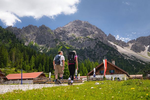 wanderung-zur-eppzirler-alm-im-sommer-mann-und-frau-von-hinten-mit-eppzirler-alm-1-1