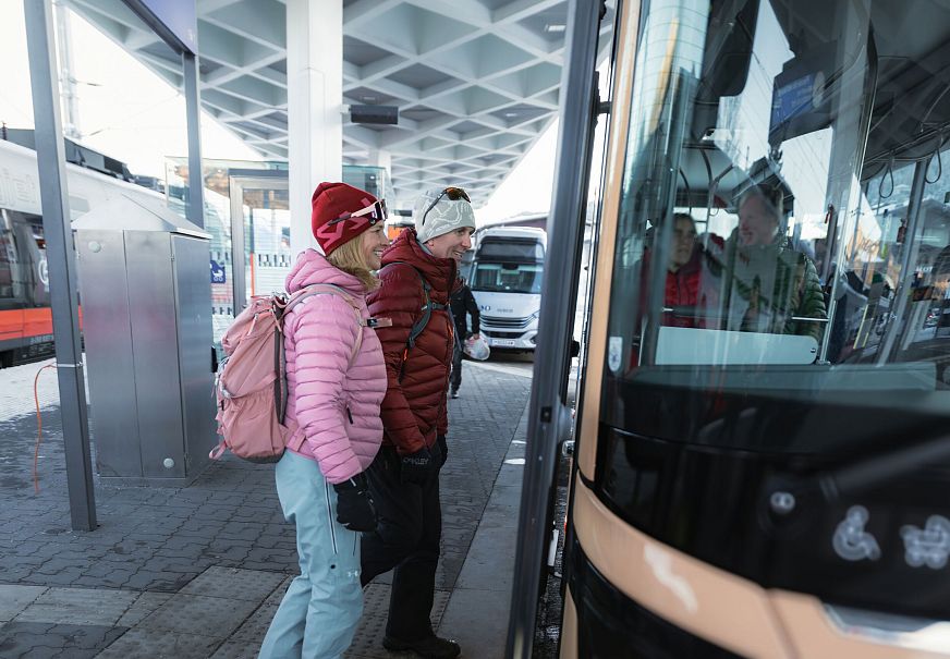 sub1-winterwandern-in-der-region-seefeld-mann-und-frau-steigen-in-bus-in-seefeld-ein